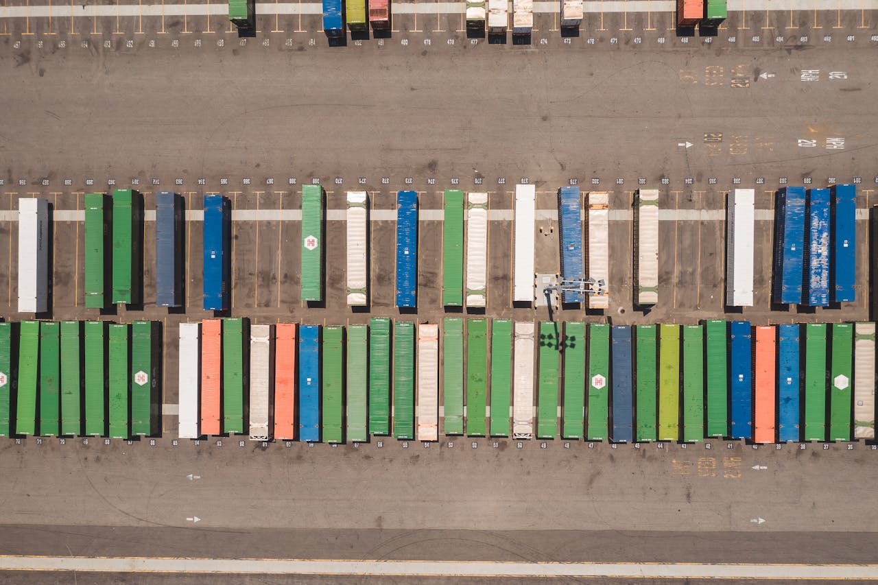 Top view of neatly arranged cargo containers in a shipping port, highlighting logistics and global trade.